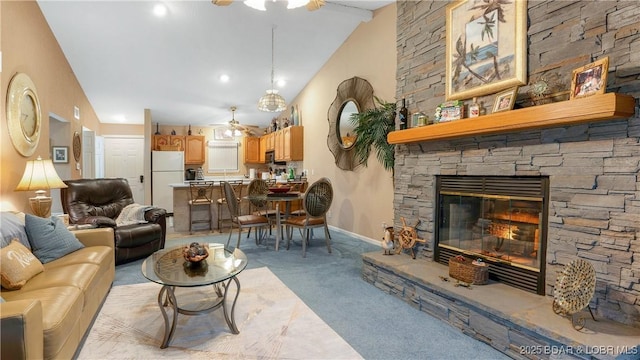 611 Lazy Days Rd Unit X-10, Osage Beach, MO 65065 - living area featuring light carpet, a ceiling fan, a fireplace, vaulted ceiling, and baseboards