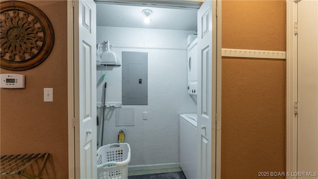 611 Lazy Days Rd Unit X-10, Osage Beach, MO 65065 - clothes washing area featuring estacked washer and dryer, electric panel, and baseboards