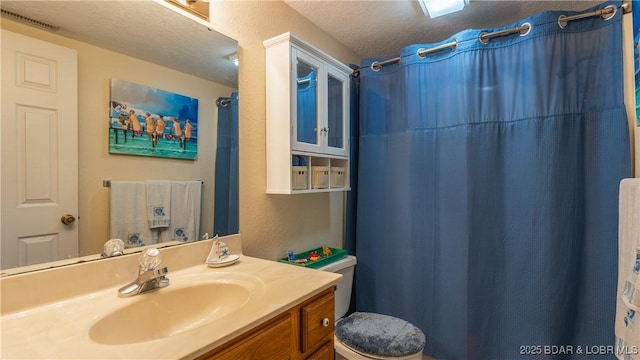 611 Lazy Days Rd Unit X-10, Osage Beach, MO 65065 - bathroom with vanity, a textured ceiling, toilet, and a shower with shower curtain