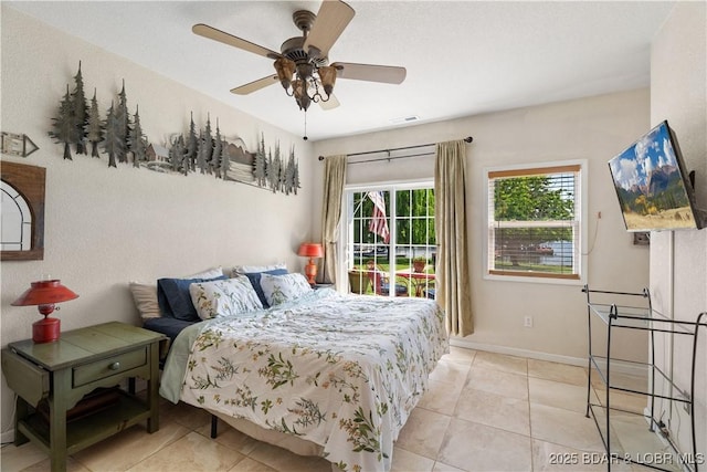 30566 Johnson Bay Dr, Gravois Mills, MO 65037 - bedroom with light tile patterned floors, baseboards, and ceiling fan