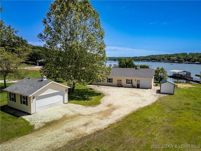 30566 Johnson Bay Dr, Gravois Mills, MO 65037 - single story home featuring an outbuilding, a water view, a detached garage, and a front lawn