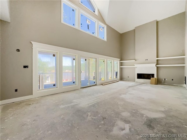 17 Eagles Pass, Climax Springs, MO 65324 - unfurnished living room with high vaulted ceiling, healthy amount of natural light, and a fireplace
