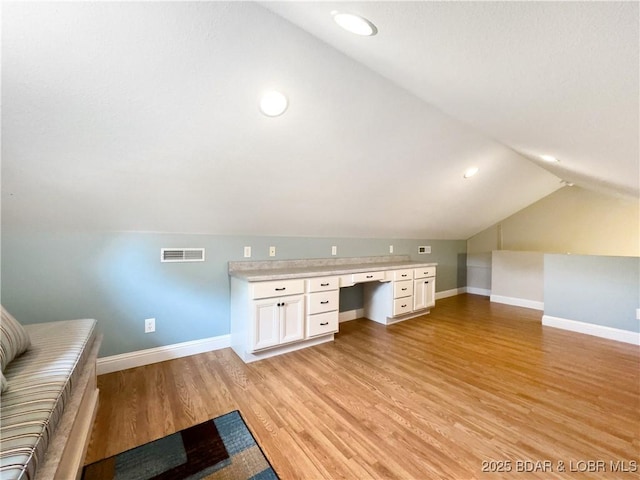 unfurnished office with lofted ceiling, baseboards, light wood-style floors, built in study area, and recessed lighting