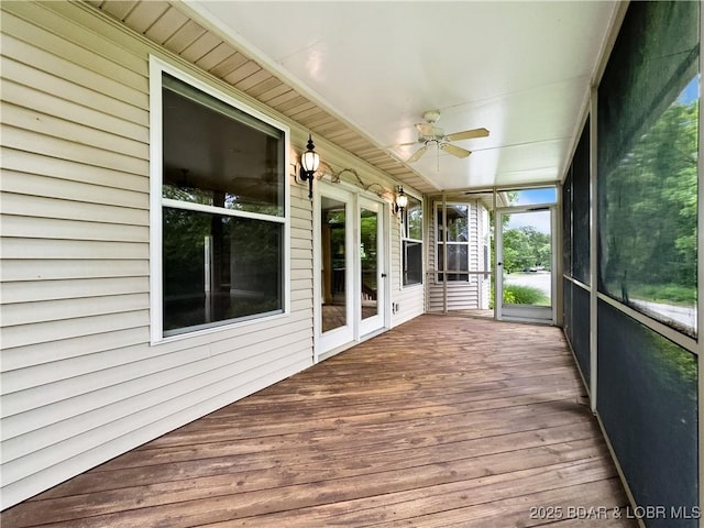 unfurnished sunroom with a ceiling fan