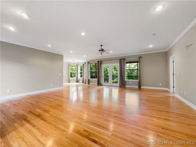 unfurnished living room featuring ornamental molding, healthy amount of natural light, ceiling fan, recessed lighting, and light wood finished floors