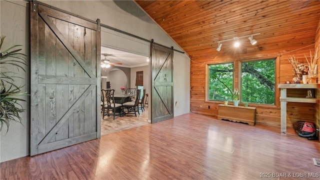 5 Hallie Ln, Kaiser, MO 65047 - spare room featuring a barn door, wood finished floors, vaulted ceiling, wooden ceiling, and wood walls