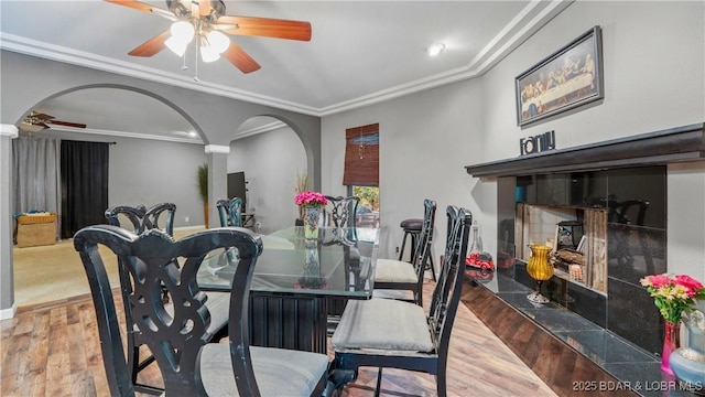 5 Hallie Ln, Kaiser, MO 65047 - dining room with a ceiling fan, wood finished floors, arched walkways, crown molding, and recessed lighting