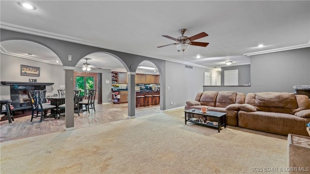5 Hallie Ln, Kaiser, MO 65047 - carpeted living room with a ceiling fan, recessed lighting, arched walkways, ornamental molding, and decorative columns