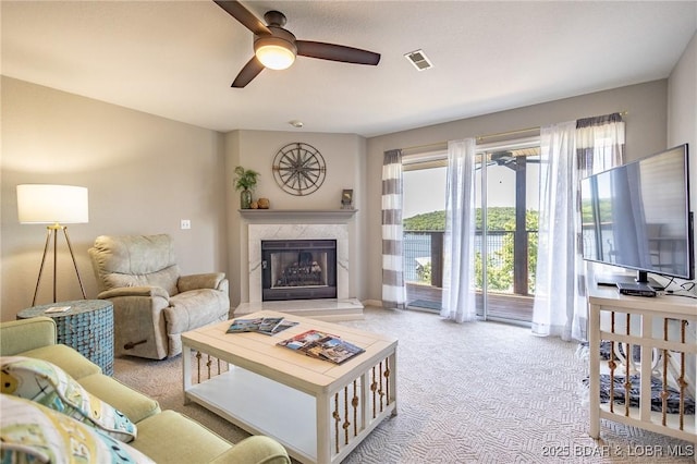 601 Park Place Dr Unit 2B, Kaiser, MO 65047 - living area with a ceiling fan, light colored carpet, and a premium fireplace