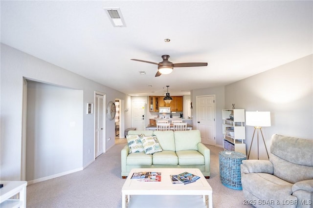 601 Park Place Dr Unit 2B, Kaiser, MO 65047 - living room featuring light colored carpet, a ceiling fan, and baseboards
