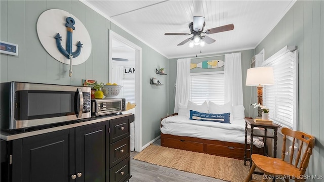 15219 Fleener Dr, Gravois Mills, MO 65037 - living area with ornamental molding, healthy amount of natural light, wood finished floors, a ceiling fan, and baseboards