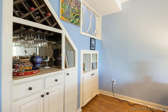 241 Shell Bay Cir Unit 1A, Linn Creek, MO 65052 - bar with light wood-style flooring and baseboards
