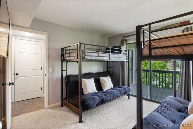 241 Shell Bay Cir Unit 1A, Linn Creek, MO 65052 - bedroom featuring carpet flooring, access to exterior, and baseboards