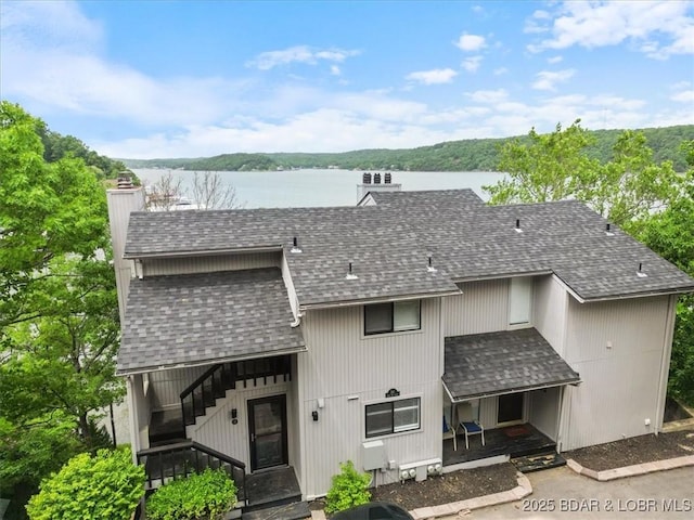 241 Shell Bay Cir Unit 1A, Linn Creek, MO 65052 - view of front facade featuring a shingled roof, a chimney, and a water view