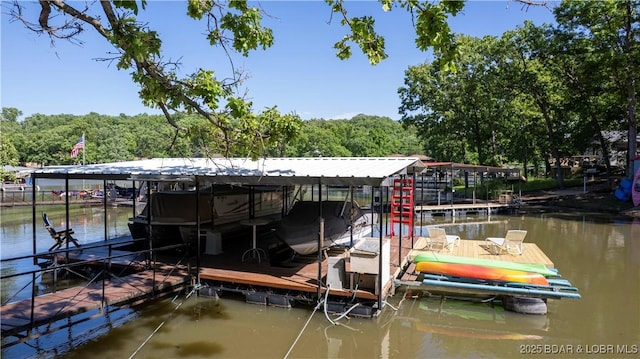 dock featuring boat lift, a water view, and a wooded view