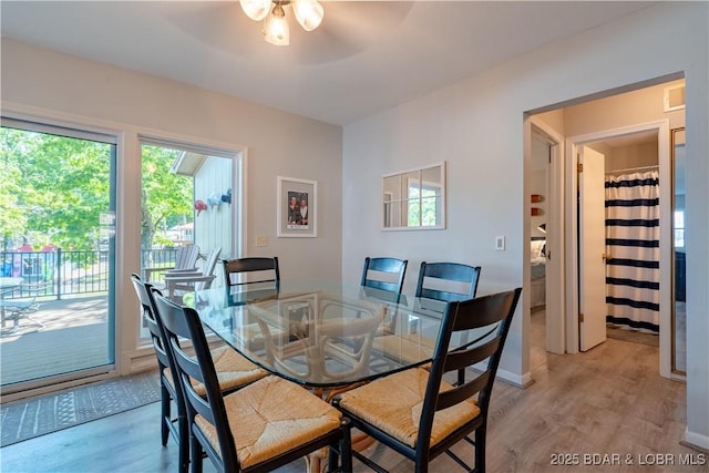 dining space featuring light wood-style floors and ceiling fan