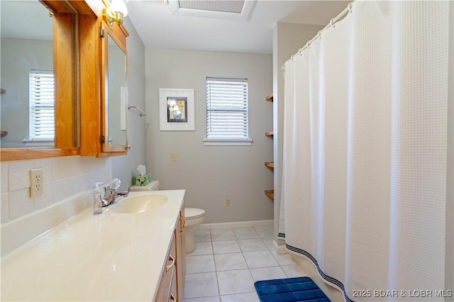 bathroom with vanity, toilet, and tile patterned flooring