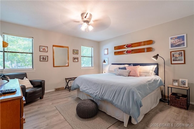bedroom featuring light wood-style floors, baseboards, and ceiling fan