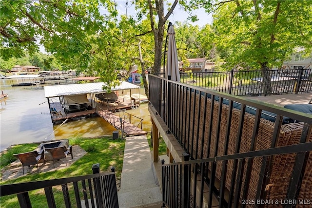 view of yard featuring a water view and a boat dock