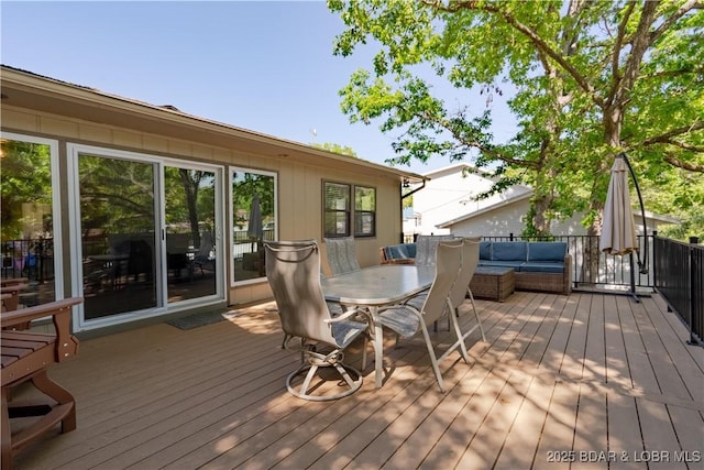wooden deck with an outdoor living space and outdoor dining space