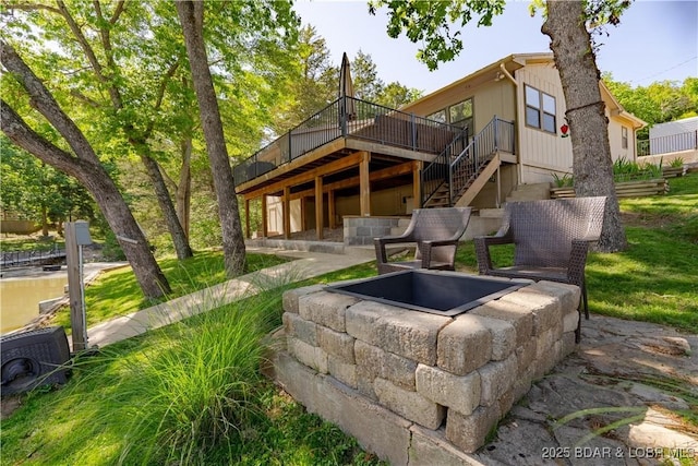 rear view of house featuring a wooden deck and stairway