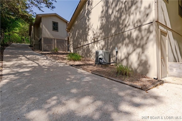 view of side of home featuring central AC unit
