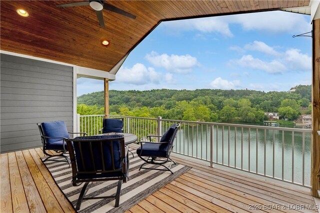 205 Wedge Wood Dr, Camdenton, MO 65020 - deck with a wooded view, a ceiling fan, and a water view
