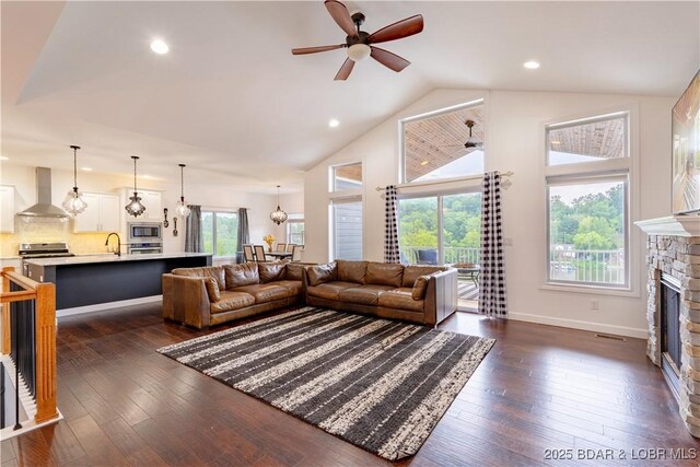 205 Wedge Wood Dr, Camdenton, MO 65020 - living room with ceiling fan, a fireplace, plenty of natural light, recessed lighting, and dark wood-style flooring
