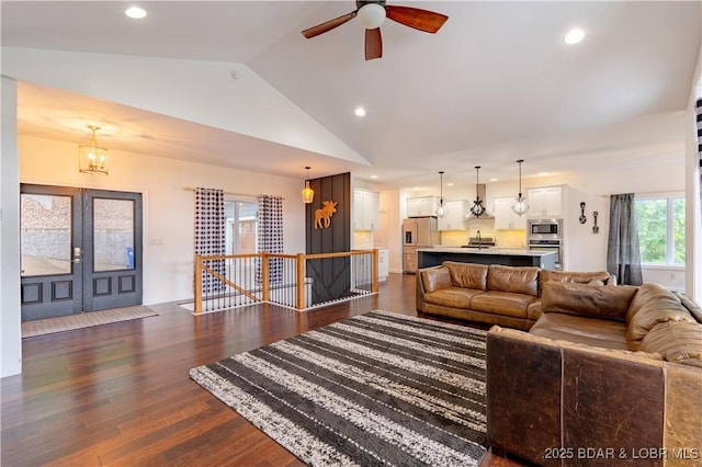 205 Wedge Wood Dr, Camdenton, MO 65020 - living room with vaulted ceiling, recessed lighting, dark wood-style floors, ceiling fan, and a chandelier