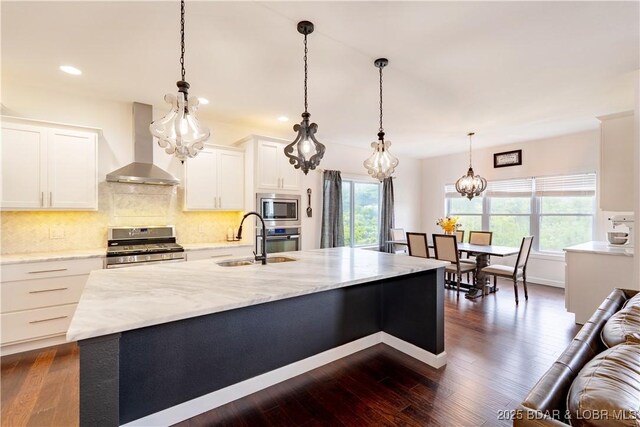 205 Wedge Wood Dr, Camdenton, MO 65020 - kitchen with wall chimney range hood, a sink, stainless steel appliances, recessed lighting, and white cabinetry