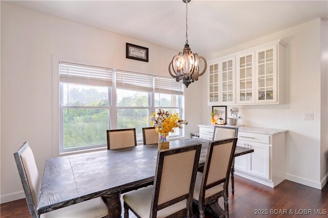 205 Wedge Wood Dr, Camdenton, MO 65020 - dining space with a chandelier, baseboards, dark wood-style flooring, and healthy amount of natural light