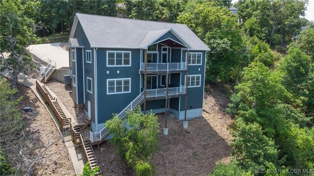 205 Wedge Wood Dr, Camdenton, MO 65020 - back of property with stairway, a balcony, and a shingled roof