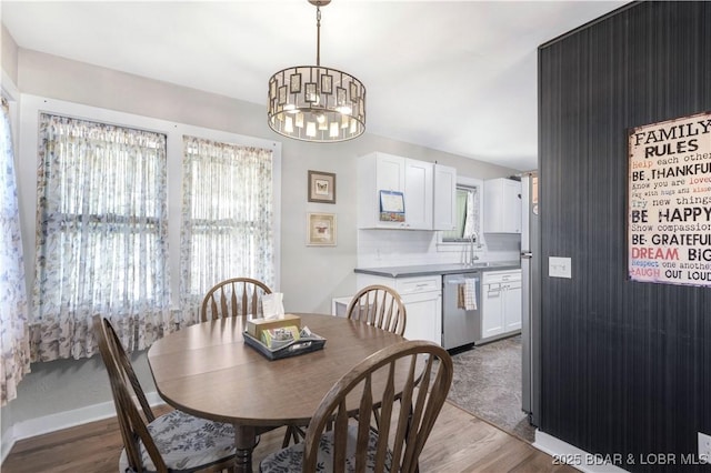 577 Mulberry Ln, Camdenton, MO 65020 - dining area with wood finished floors, plenty of natural light, a chandelier, and baseboards