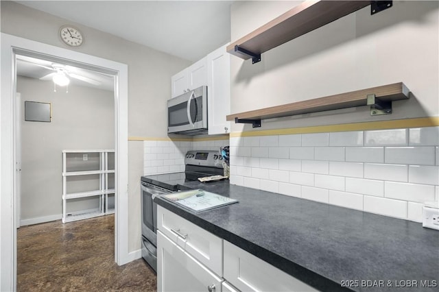 577 Mulberry Ln, Camdenton, MO 65020 - kitchen with stainless steel appliances, open shelves, dark countertops, white cabinetry, and tasteful backsplash