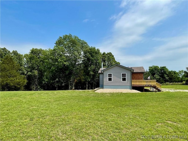 view of grassy yard featuring a deck