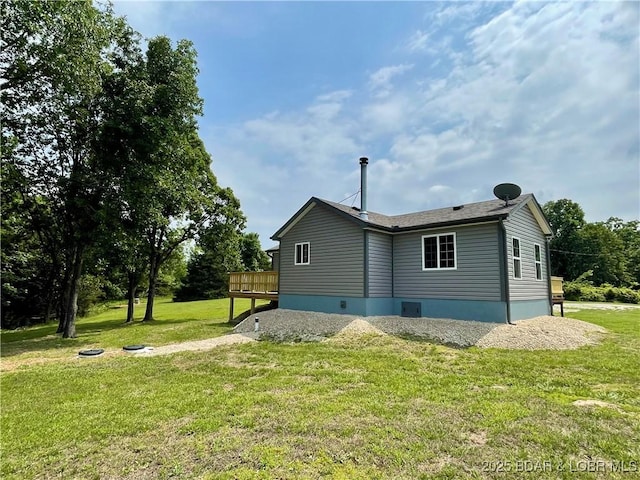 rear view of property featuring a lawn and a wooden deck