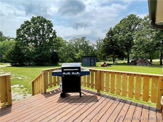 wooden terrace with a yard, a grill, and view of scattered trees
