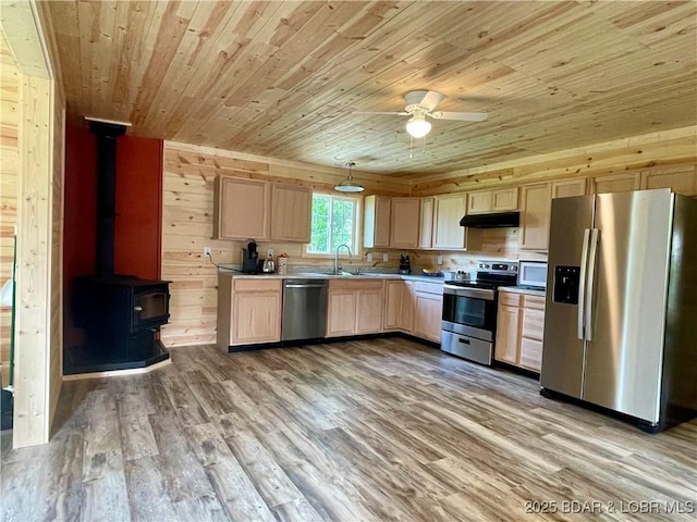 kitchen with appliances with stainless steel finishes, wood ceiling, light brown cabinets, under cabinet range hood, and light wood-style floors