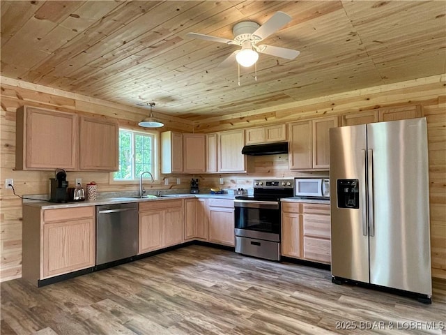 kitchen with stainless steel appliances, wood ceiling, light brown cabinetry, under cabinet range hood, and a sink