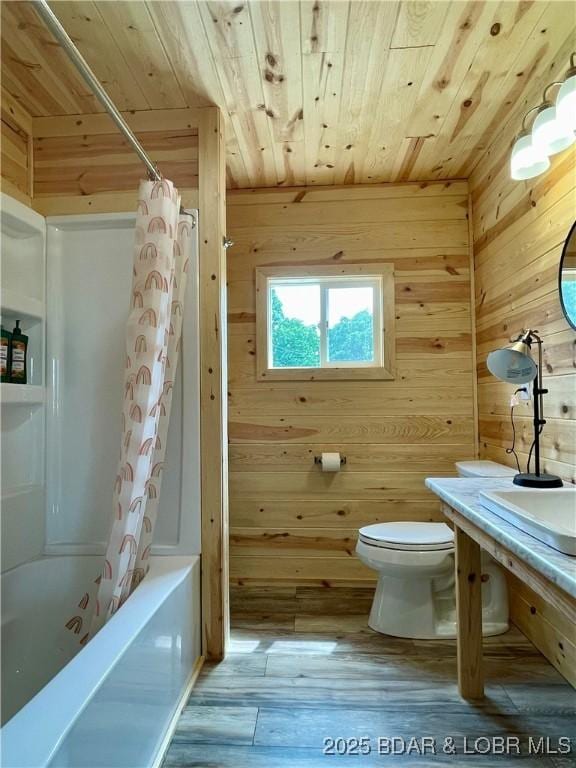bathroom featuring wood ceiling, wooden walls, toilet, wood finished floors, and shower / bath combo with shower curtain