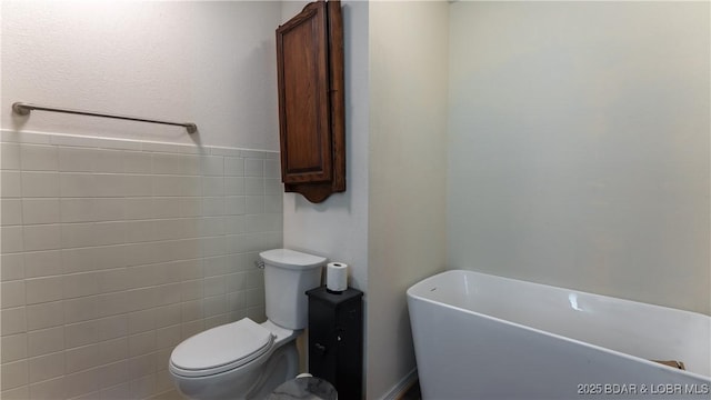 312 Charger Dr, Macks Creek, MO 65786 - bathroom featuring a soaking tub and toilet