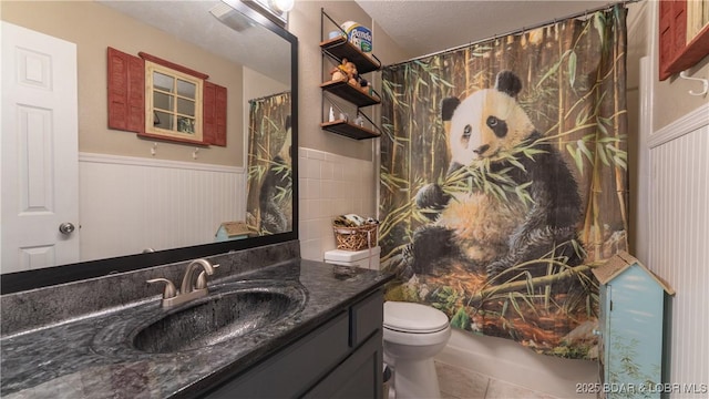 312 Charger Dr, Macks Creek, MO 65786 - bathroom featuring tile patterned flooring, vanity, toilet, a wainscoted wall, and a shower with curtain