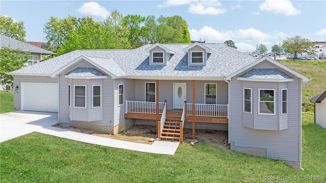 103 Primrose Ln, Camdenton, MO 65020 - view of front facade featuring a garage, a porch, roof with shingles, concrete driveway, and a front lawn