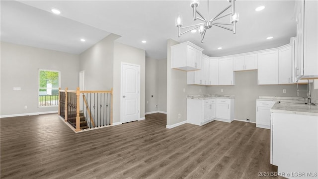 103 Primrose Ln, Camdenton, MO 65020 - kitchen with dark wood finished floors, baseboards, white cabinetry, light stone countertops, and recessed lighting