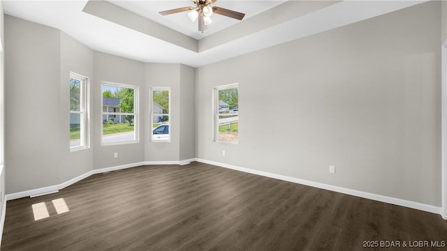 103 Primrose Ln, Camdenton, MO 65020 - spare room with dark wood finished floors, a raised ceiling, baseboards, and a ceiling fan