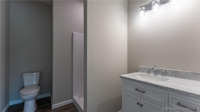103 Primrose Ln, Camdenton, MO 65020 - bathroom featuring vanity, wood finished floors, toilet, and baseboards