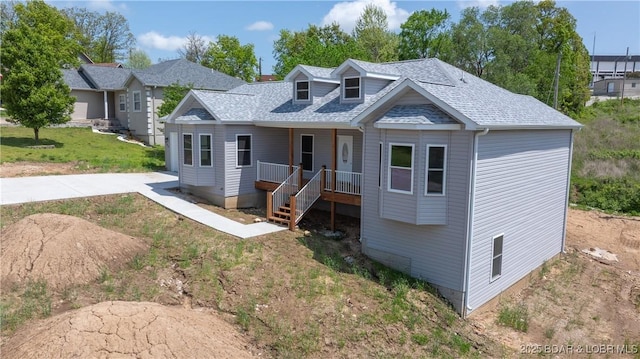 103 Primrose Ln, Camdenton, MO 65020 - view of front of house featuring roof with shingles, a porch, and a front yard