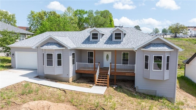 103 Primrose Ln, Camdenton, MO 65020 - cape cod-style house featuring covered porch, a garage, a shingled roof, concrete driveway, and stairs