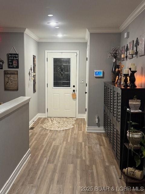 362 Merlin Dr, Camdenton, MO 65020 - entrance foyer with light wood finished floors, baseboards, crown molding, and mail area