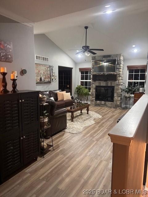 362 Merlin Dr, Camdenton, MO 65020 - living room with a ceiling fan, a fireplace, wood finished floors, vaulted ceiling, and recessed lighting